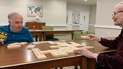 Assisted Living residents enjoying a game of Dominoes