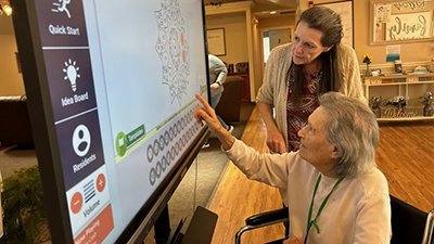Elderly woman using a touchscreen panel