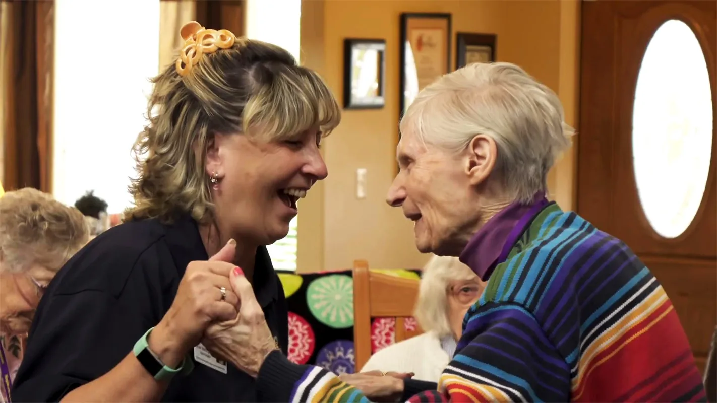 Caregiver and resident dancing