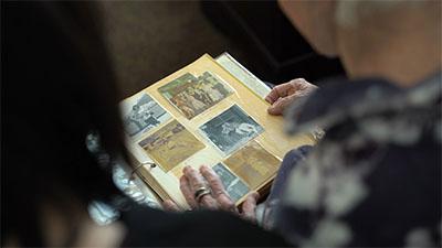 Caregiver and resident looking at old photo album