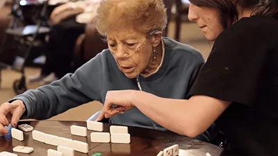 Caregivers providing elderly care activity assistance