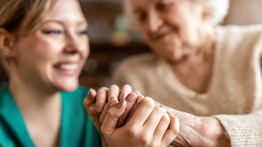 Caregiver and happy resident