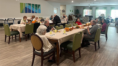 Seniors eating in a family style dining room
