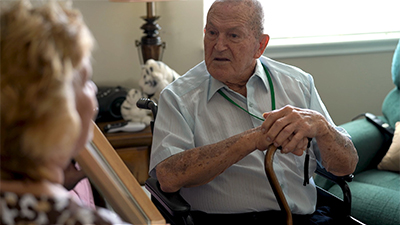 Elderly Memory Care man telling a compelling story to a compassionate caregiver