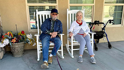 Elderly resident couple sitting outside on our lovely porch