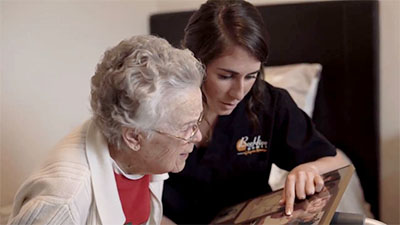 Elderly memory care resident with compassionate caregiver