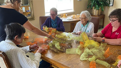 Memory care residents enjoying a crafting activity together