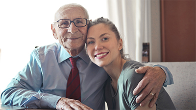 Granddaughter visits with her happy grandfather living in our assisted living home