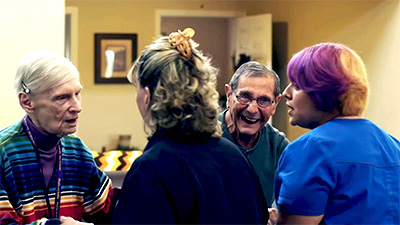 Happy seniors dancing with caregivers