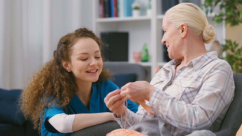 Caregiver chats with resident
