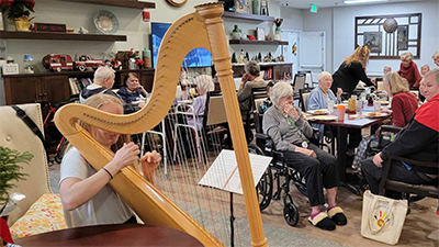 Harpist entertains residents and guests