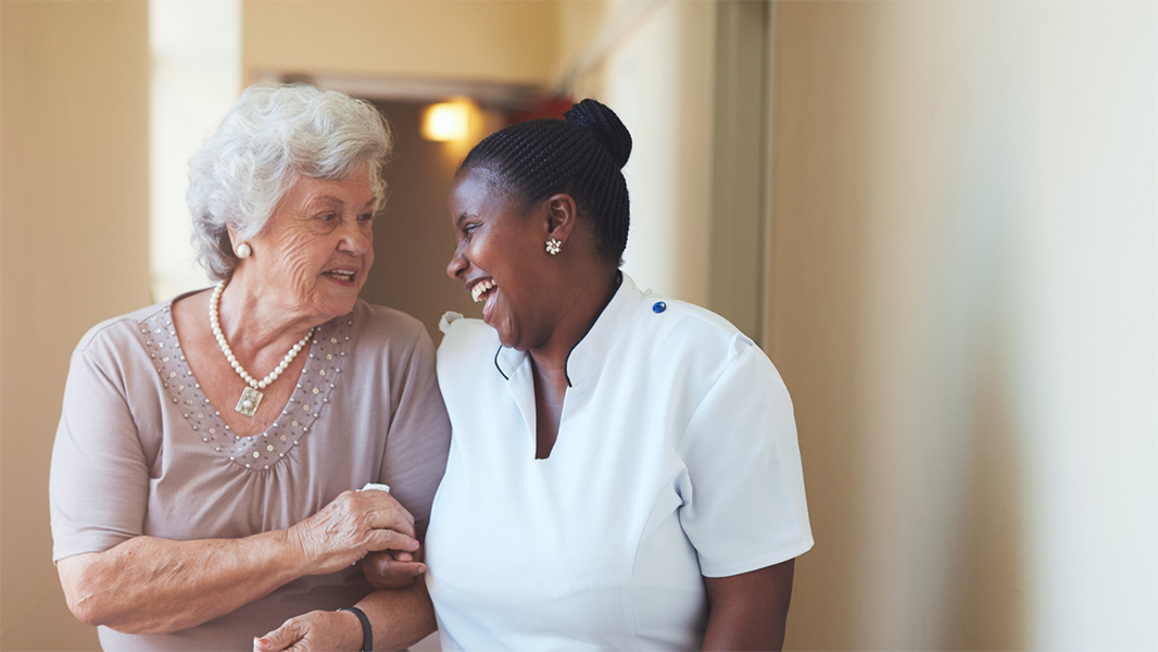 Elderly and caregiver walking