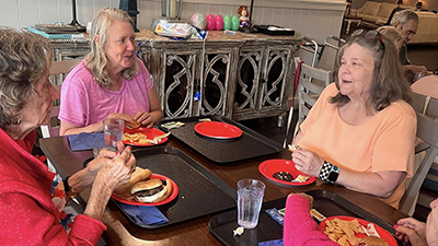 Elderly residents enjoying mealtime together