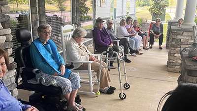 Elderly residents enjoying the covered porch