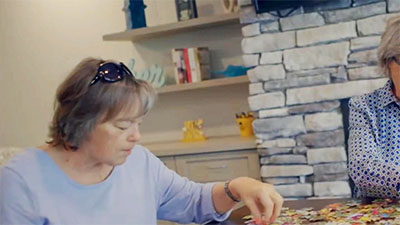 Elderly woman building a puzzle