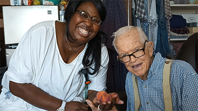 Resident and caregiver sharing a happy moment