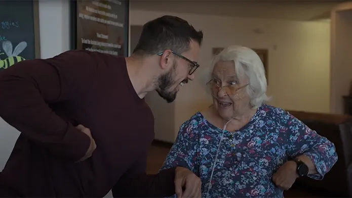 Two people dancing inside our assisted living home