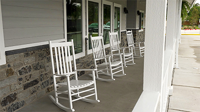 White rocking chairs on a spacious front porch