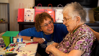 Caregiver and resident conversing together