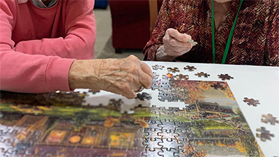 Residents building a puzzle